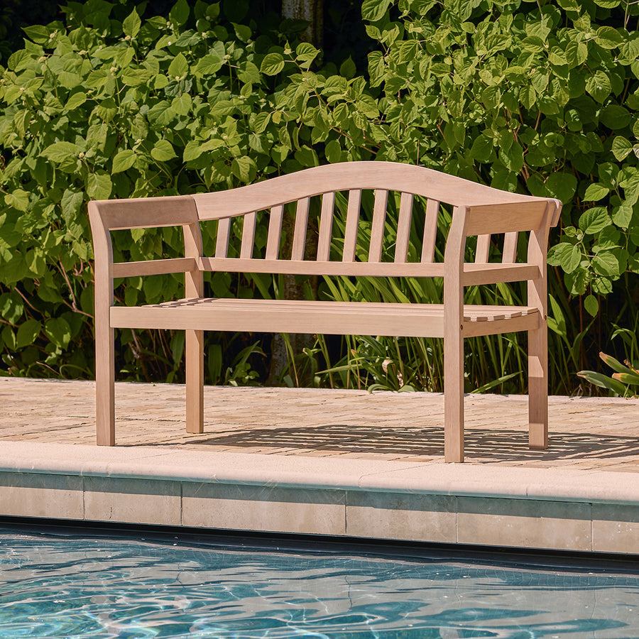 Outdoor 2 seater bench in natural wood finish placed beside a swimming pool, ideal for garden or patio seating.