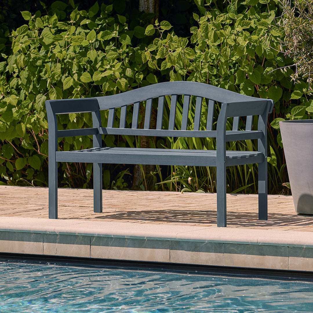 Outdoor 2 seater bench in a dark anthracite grey wood finish placed beside a swimming pool, ideal for garden or patio seating.