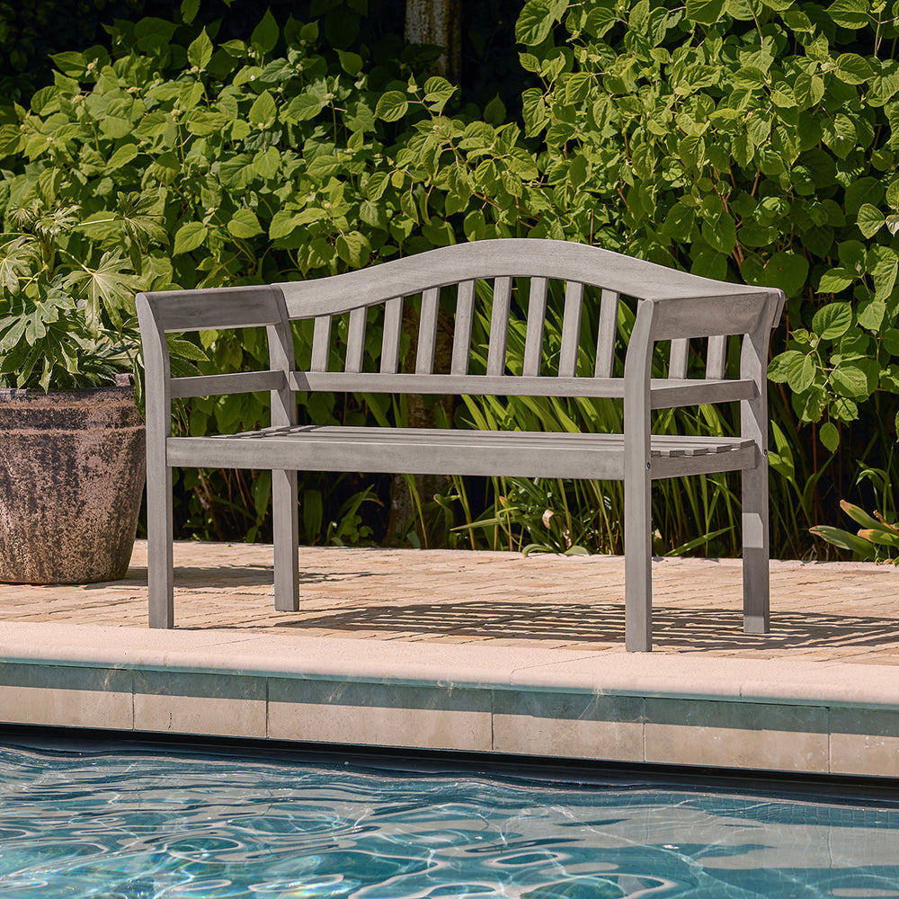 Outdoor 2 seater bench in grey wood finish placed beside a swimming pool, ideal for garden or patio seating.