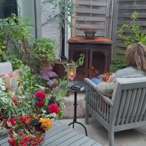 Outdoor fireplace styling video featuring the Wakehurst wood burner. A oxidised steel outdoor fireplace bringing warmth and ambience to a patio setting.