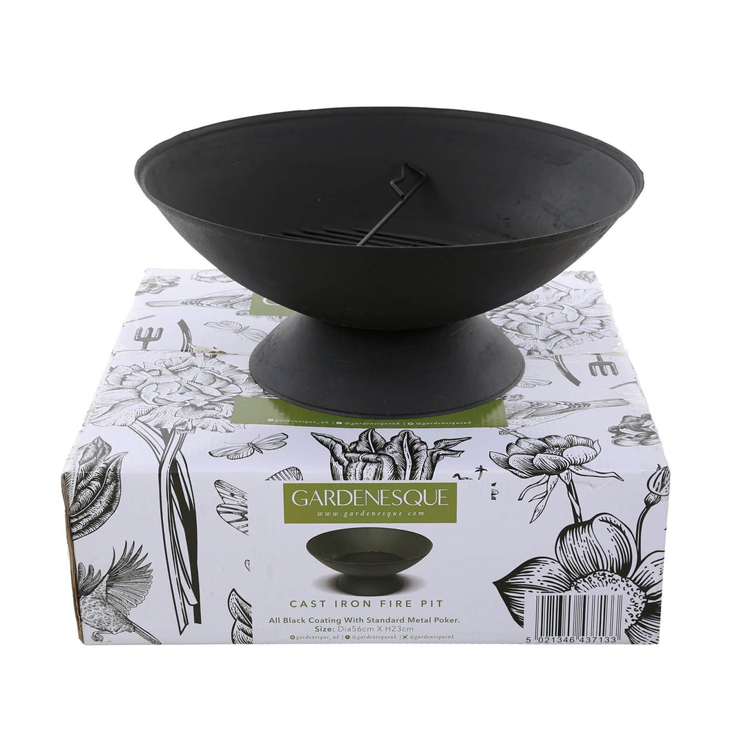 A black cast iron fire pit displayed on top of a decorative Gardenesque box, showcasing its shape and design.