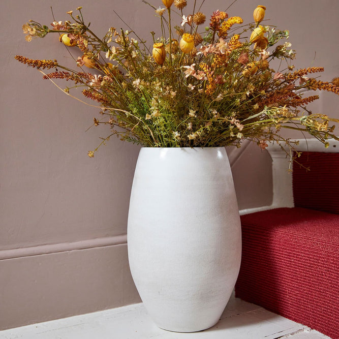 Off white ceramic vase with dried flowers