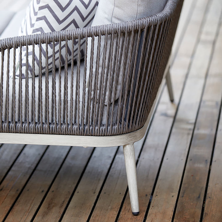 Close-up of the Richmond garden armchair, showcasing its intricate rope-weave backrest and durable powder-coated aluminium frame