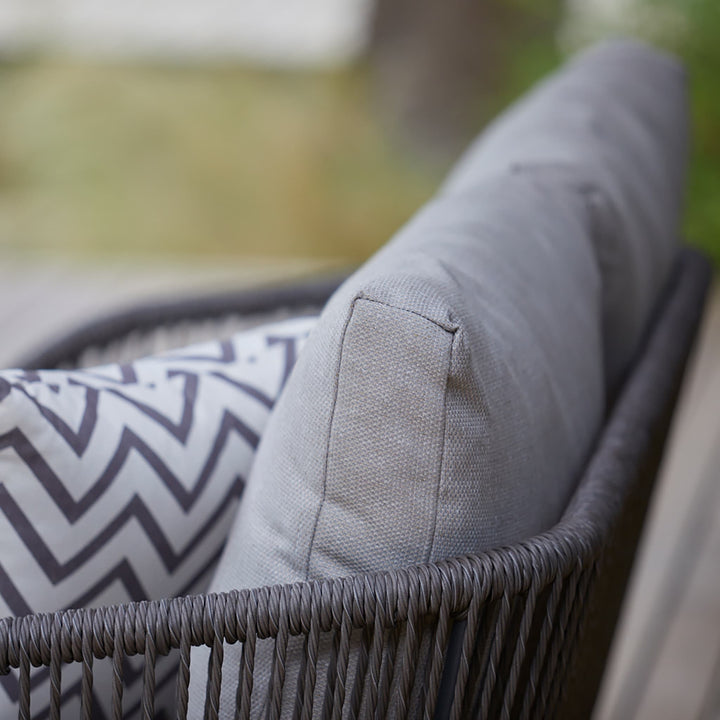 Close-up of the Richmond sofa’s rope-woven frame and soft grey cushion, highlighting the set’s elegant craftsmanship and weather-resistant materials.